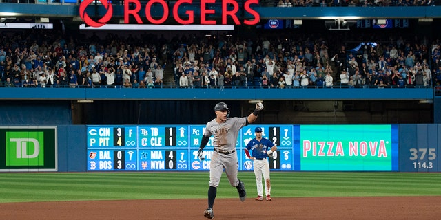 New York Yankees designated hitter Aaron Judge runs the bases after hitting his 61st home run of the season, a two-run shot against the Toronto Blue Jays during the seventh inning of a baseball game Wednesday, Sept .  28, 2022, in Toronto.