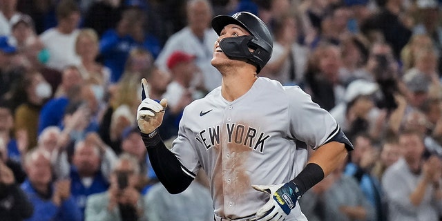 New York Yankees' Aaron Judge celebrates his 61st home run of the season, a two-run homer against the Toronto Blue Jays during the seventh inning of a baseball game Wednesday, Sept. 28, 2022, in Toronto.