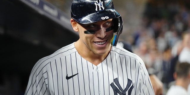 Aaron Judge, #99 of the New York Yankees, reacts in the dugout after hitting his 60th home run of the season in the ninth inning during the game between the Pittsburgh Pirates and the New York Yankees at Yankee Stadium on Tuesday, Sept. 20, 2022 in New York, New York.