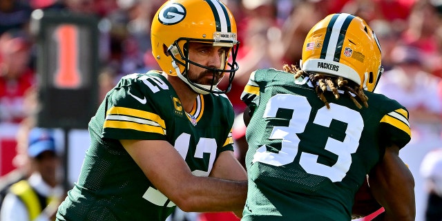 Aaron Rodgers #12 of the Green Bay Packers hands the ball off to Aaron Jones #33 against the Tampa Bay Buccaneers during the first quarter in the game at Raymond James Stadium on September 25, 2022 in Tampa, Florida.