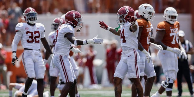 Jordan Battle #9 of the Alabama Crimson Tide congratulates Brian Branch #14 after a tackle in the first half against the Texas Longhorns at Darrell K Royal-Texas Memorial Stadium on September 10, 2022 in Austin, Texas.