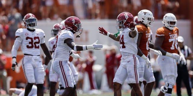 Jordan Battle, #9 of the Alabama Crimson Tide, congratulates Brian Branch, #14, after a tackle in the first half against the Texas Longhorns at Darrell K Royal-Texas Memorial Stadium on Sept. 10, 2022 in Austin, Texas.