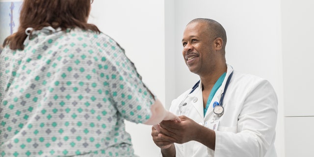 Dr. Carl Allamby treats a patient. He began medical school in 2015 at Northeast Ohio Medical University and said he was 