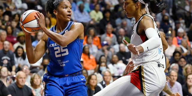 Connecticut Sun's Alyssa Thomas, left, looks to pass while Las Vegas Aces' A'ja Wilson defends during the first half in Game 3 of a WNBA basketball final playoff series, Thursday, Sept. 15, 2022, in Uncasville, Conn. 