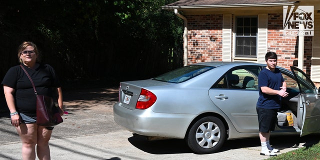 Amanda Bearden and Andrew Giegerich arrive together at her house Friday. Bearden's mother Debbie Collier was found dead under gruesome circumstances off a rural highway earlier this month.