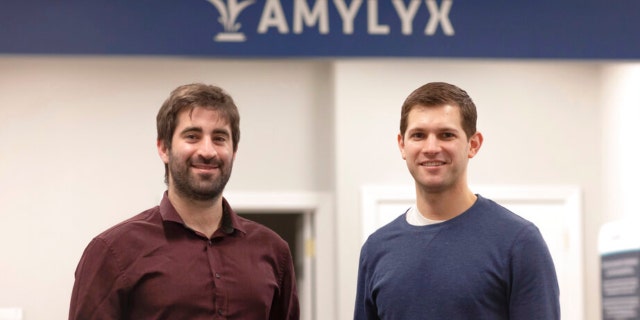 This 2018 photo provided by Amylyx shows the company's co-founders Joshua Cohen, left, and Justin Klee in Cambridge, Mass. 