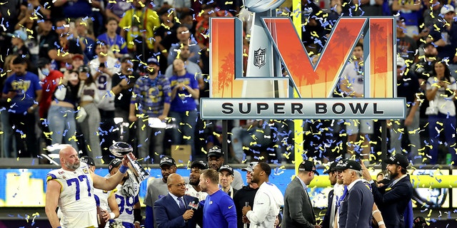 Andrew Whitworth, #77 of the Los Angeles Rams, holds up the Vince Lombardi Trophy after Super Bowl LVI at SoFi Stadium on February 13, 2022 in Inglewood, California.