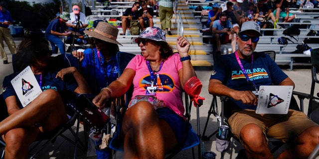 People wait for the NASA lunar rocket launch pad 39B before the Artemis 1 mission to orbit the Moon at the Kennedy Space Center, Saturday, Sept. 3, 2022, in Cape Canaveral, Florida. 