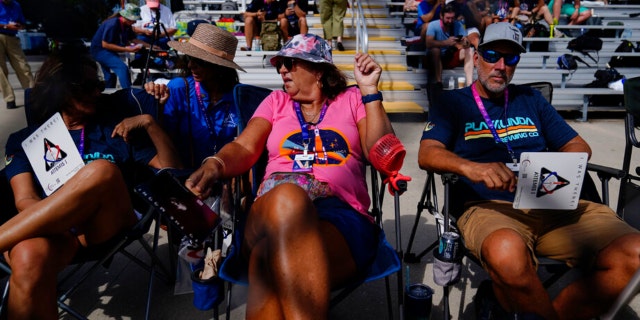 People wait for the NASA moon rocket to launch on Pad 39B before the Artemis 1 mission to orbit the moon at the Kennedy Space Center, Saturday, Sept. 3, 2022, in Cape Canaveral, Fla.
