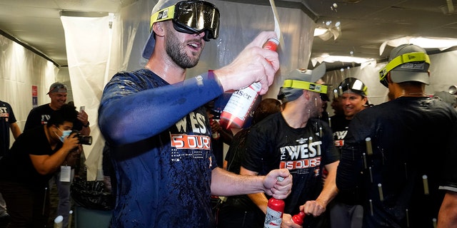 Houston Astros players celebrate in the clubhouse after clinching the American League West title with a win over the Tampa Bay Rays during a baseball game Monday, Sept. 19, 2022, in St. Petersburg, Fla. 