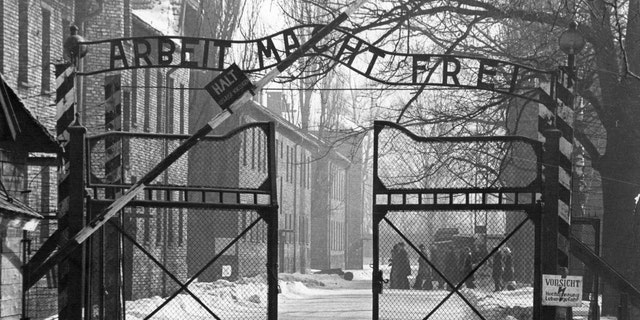 View of the main entrance to the Auschwitz camp. The sign above the gate says "Arbeit Macht Frei" (Work makes one free). Auschwitz, Poland/