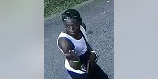 Murder suspect Avery Miler seen wielding gun in photo released by DC police. 