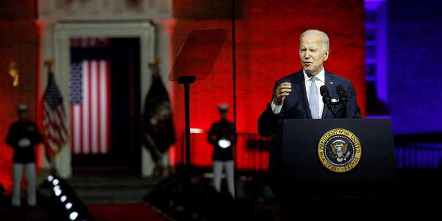 President Joe Biden, protected by bulletproof glass, delivers remarks on what he calls the 