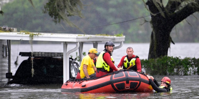 First responders with Orange County Fire Rescue use an inflatable boat to rescue a resident from a home in the aftermath of Hurricane Ian, Thursday, Sept. 29, 2022, in Orlando, Fla.