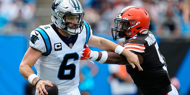 Carolina Panthers quarterback Baker Mayfield looks to pass under pressure from Cleveland Browns linebacker Anthony Walker Jr. during the first half of an NFL football game on Sunday, Sept. 11, 2022, in Charlotte, North Carolina. 