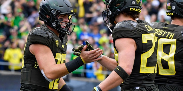 Ducks quarterback Bo Nix and wide receiver Chase Cota celebrate Nix's touchdown against BYU, Saturday, Sept. 17, 2022, in Eugene, Oregon,