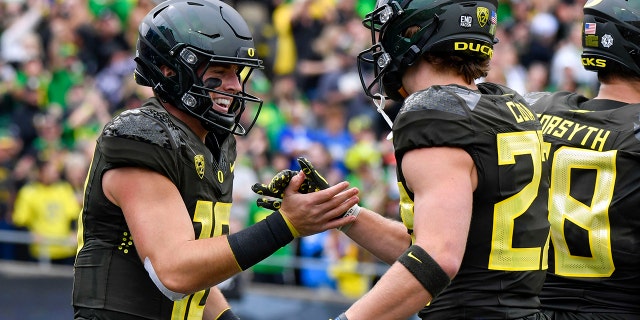 Ducks quarterback Bo Nix and wide receiver Chase Cota celebrate Nix's touchdown against BYU, Saturday, Sept. 17, 2022, in Eugene, Oregon,