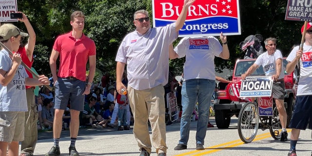 Republican congressional candidate Bob Burns marches in the Amherst, New Hampshire, Independence Day parade, on July 4, 2022.