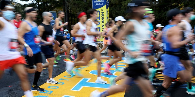 Runners cross the starting line of the 125th Boston Marathon on Monday, October 11, 2021 in Hopkinton, Massachusetts.