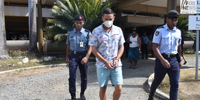 Bradley Dawson in handcuffs is escorted by Fijian police officers back to his cell block after the High Court in Lautoka dismissed his bail application.