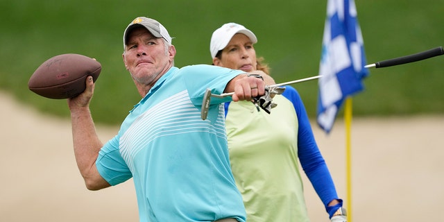 Former NFL player Brett Favre throws a football to a fan on the 14th green during the Celebrity Foursome at the second round of the American Family Insurance Championship at University Ridge Golf Club on June 11, 2022, in Madison, Wisconsin.