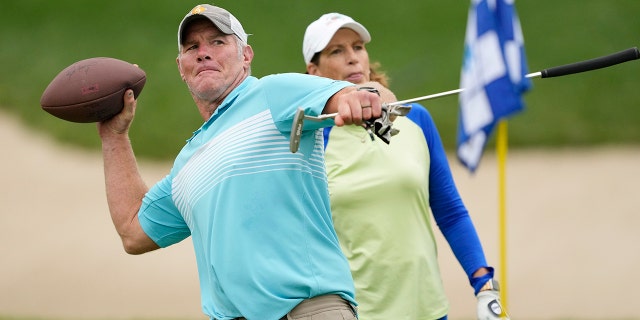 Former NFL player Brett Favre throws a football to fans on the 14th green during the Celebrity Foursome during the second round of the American Family Insurance Championship at the University Ridge Golf Club in Madison, Wisconsin on June 11, 2022.