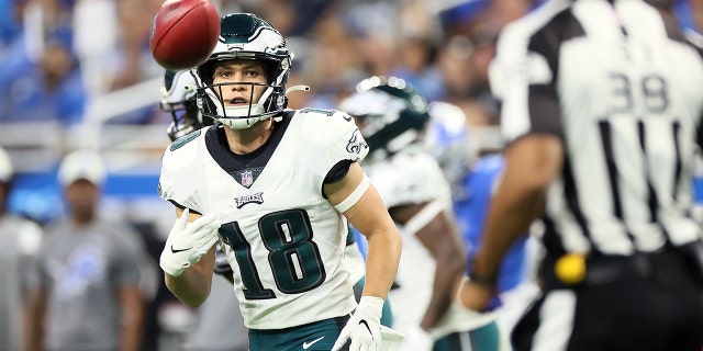 Philadelphia Eagles wide receiver Britain Covey, #18, tosses the ball to back judge Rich Martinez, #39, during an NFL football game between the Detroit Lions and the Philadelphia Eagles in Detroit on Sunday, Sept. 11, 2022.