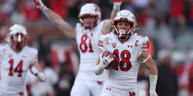 Britain Covey, #18 of the Utah Utes, rushes for a touchdown against the Ohio State Buckeyes during the second quarter in the Rose Bowl Game at Rose Bowl Stadium on Jan. 1, 2022 in Pasadena, California.