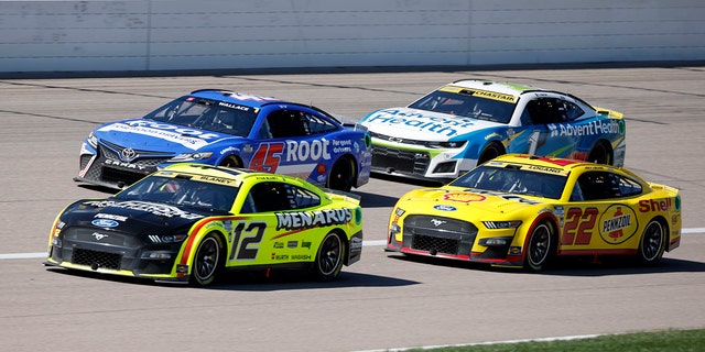 Bubba Wallace (45), Ryan Blaney (12), Ross Chastain (1) and Joey Logano (22) head toward Turn 1 during a NASCAR Cup Series auto race at Kansas Speedway in Kansas City, Kan., Sunday, Sept. 11, 2022.