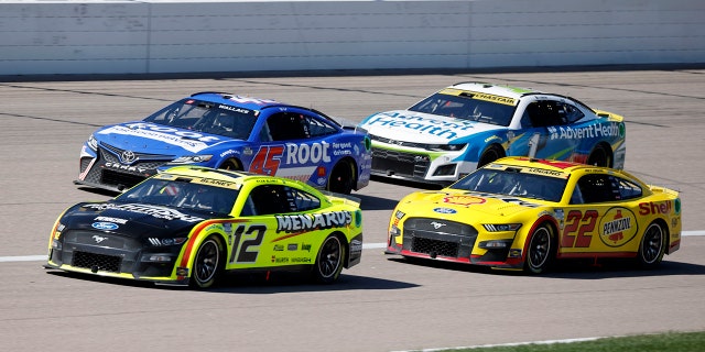 Bubba Wallace (45), Ryan Blaney (12), Ross Chastain (1) and Joey Logano (22) head toward Turn 1 during a NASCAR Cup Series auto race at Kansas Speedway in Kansas City, Kan., Sunday, Sept. 11, 2022.