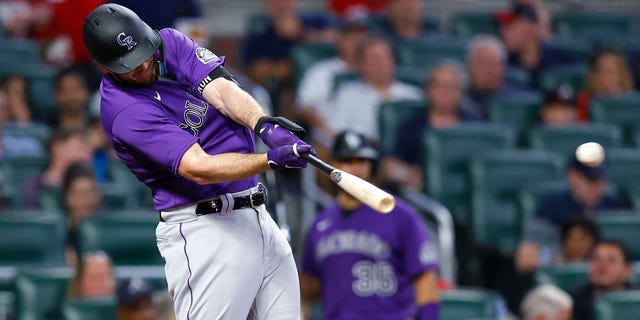 C.J. Cron of the Colorado Rockies hits an RBI single during the fourth inning against the Atlanta Braves at Truist Park Aug. 30, 2022, in Atlanta. 