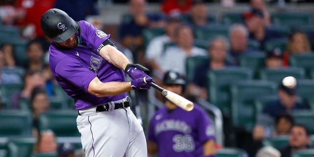 C.J. Cron of the Colorado Rockies hits an RBI single during the fourth inning against the Atlanta Braves at Truist Park Aug. 30, 2022, in Atlanta.