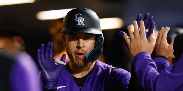 C.J. Cron of the Colorado Rockies is congratulated in the dugout after hitting a solo home run in the fourth inning against the Arizona Diamondbacks at Coors Field Sept. 9, 2022, in Denver.