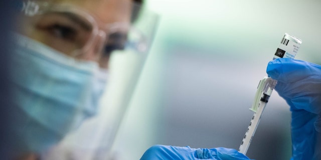 Encino, CA - September 08: Ria Garcia, an LVN with Los Angeles County Department of Public Health, draws up monkeypox vaccines at the Balboa Sports Complex vaccine site in Encino on Sept. 8, 2022. 