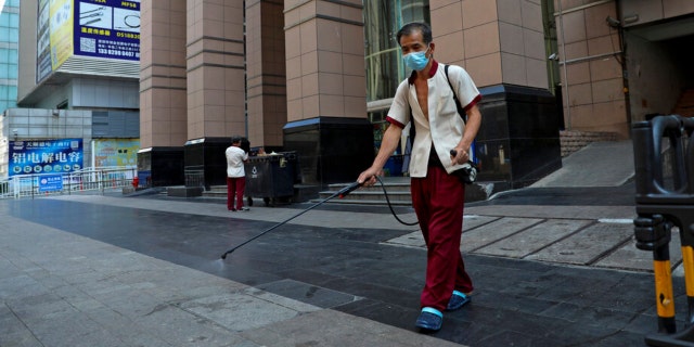 A worker sprays disinfectant around the shuttered Huaqiangbei Electronics Market following the coronavirus outbreak in Shenzhen in south China's Guangdong province on Sept. 3, 2022.