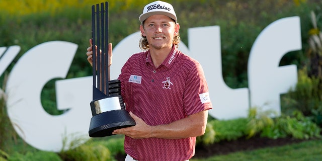 Cameron Smith poses with the champion's trophy after winning the LIV Golf Invitational-Chicago tournament Sunday, Sept. 18, 2022, in Sugar Hill, Ill.