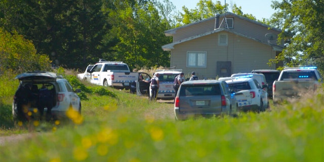 In this image taken from video, Canadian law enforcement officers surrounded a residence on the James Smith Cree First Nation Reservation in Saskatchewan, Canada, on Tuesday, Sept. 6, 2022, and arrested a suspect in a series of stabbings. Searching.