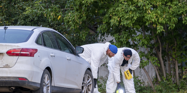 Investigators examine the ground at the scene of a stabbing in Weldon, Saskatchewan on Sunday, Sept. 4.