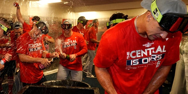 St. Louis Cardinals' Jack Flaherty, right, celebrates with teammates including Andrew Knizner, center, and Tommy Edman, left, after defeating the Milwaukee Brewers in a baseball game to win the National League Central title Tuesday, Sept. 27, 2022, in Milwaukee.