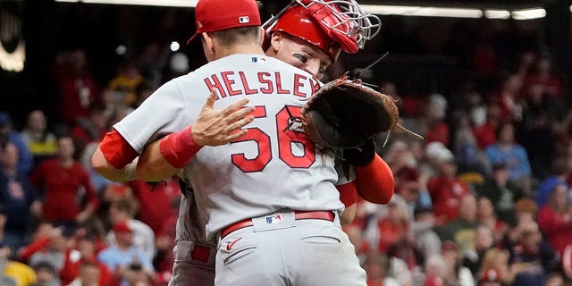 St. Louis Cardinals' Andrew Knizner and Ryan Helsley celebrate after defeating the Milwaukee Brewers in a baseball game to win the National League Central title Tuesday, Sept. 27, 2022, in Milwaukee.