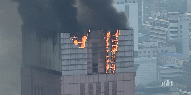 Flames and smoke rise from a 218-meter-tall office building on Sept. 16, 2022 in Changsha, Hunan Province of China.