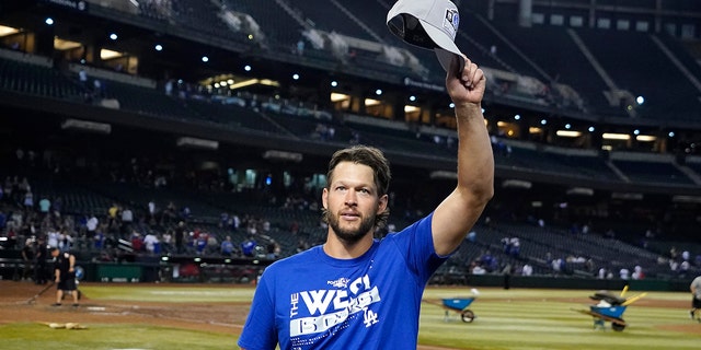 Los Angeles Dodgers pitcher Clayton Kershaw waves to Dodgers fans after the team's 4-0 win against the Arizona Diamondbacks in Phoenix, Sept. 13, 2022.