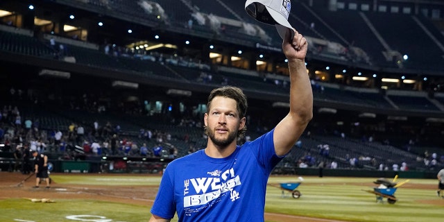 Los Angeles Dodgers pitcher Clayton Kershaw waves to Dodgers fans after the team's 4-0 win against the Arizona Diamondbacks in Phoenix, Sept. 13, 2022.