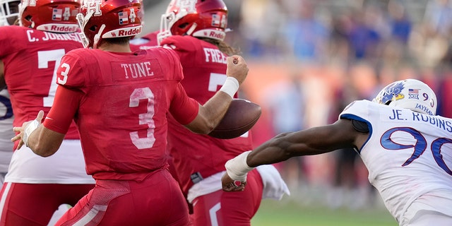 Kansas' Jereme Robinson strips the ball from Cougars quarterback Clayton Tune, Saturday, Sept. 17, 2022, in Houston.