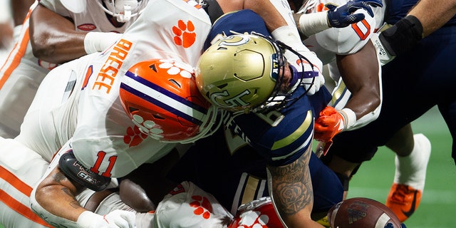 Clemson defensive tackle Bryan Bresee, #11, tackles Georgia Tech running back Dylan McDuffie, #6, in the first half of an NCAA college football game Monday, Sept. 5, 2022, in Atlanta.