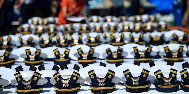 The new hats and shoulder bars for graduates sit on a table before the start of the U.S. Coast Guard Academy's 141st Commencement Exercises in New London, Connecticut, on May 18, 2022.