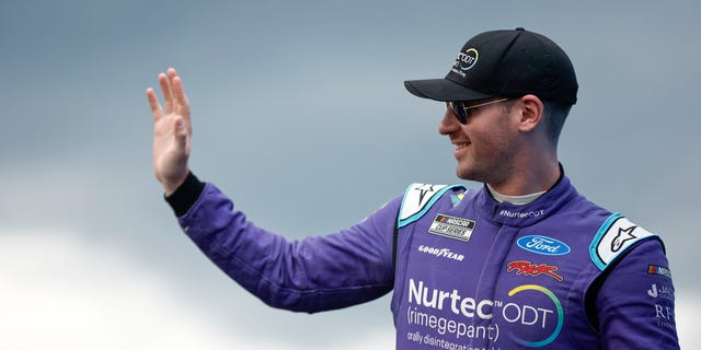 Cody Ware, driver of the No. 51 Nurtec ODT Ford, waves to fans as he walks onstage during driver intros prior to the Go Bowling at The Glen at Watkins Glen International on Aug. 21, 2022, in Watkins Glen, New York.