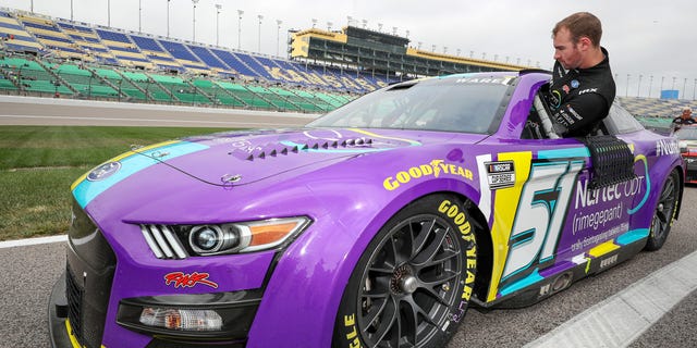 Cody Ware, driver of the No. 51 Nurtec ODT Ford, gets in his car during qualifying for the Hollywood Casino 400 at Kansas Speedway in Kansas City on Sept. 10, 2022.