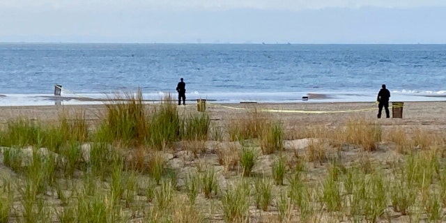 New York Police investigators examine a stretch of beach at Coney Island where three children were found dead in the surf Monday, Sept. 12, 2022, in New York. Authorities have confirmed that the children died by drowning.