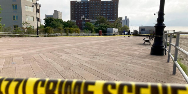 Crime scene tape stretches across a section of the Coney Island boardwalk near a stretch of beach where three children were found dead in the surf Monday, Sept. 12, 2022, in New York. 